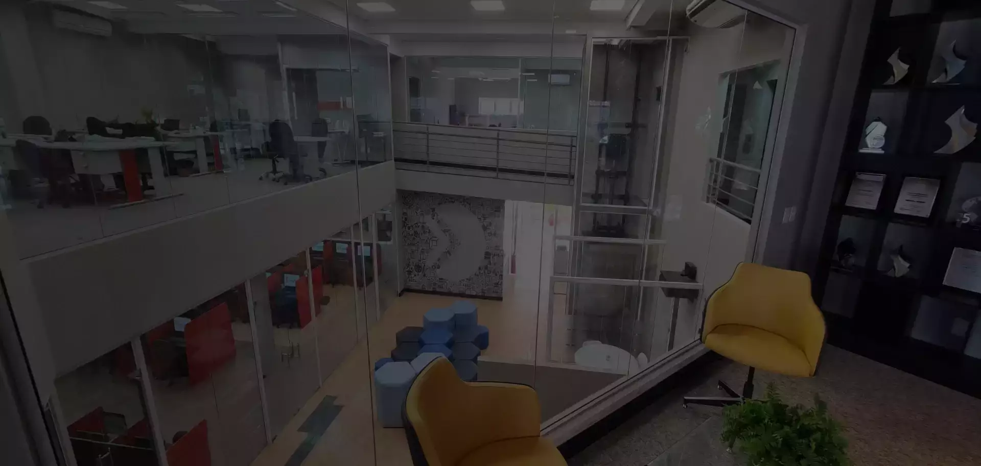 Ambiente interno de uma unidade MoveEdu, com salas de vidro e mobiliário colorido